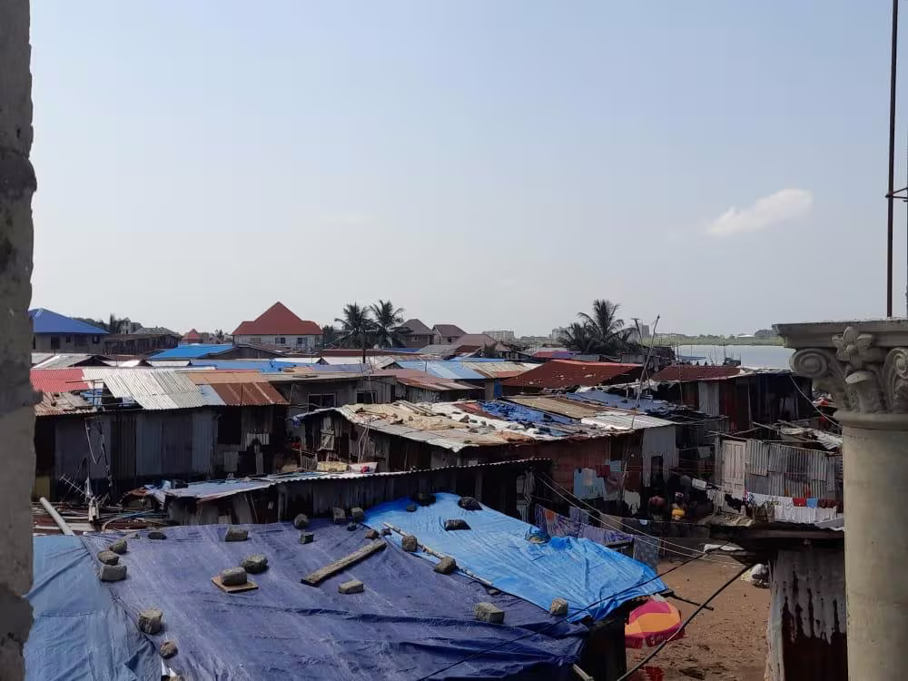Dense tin-roofed housing in a Freetown informal settlement